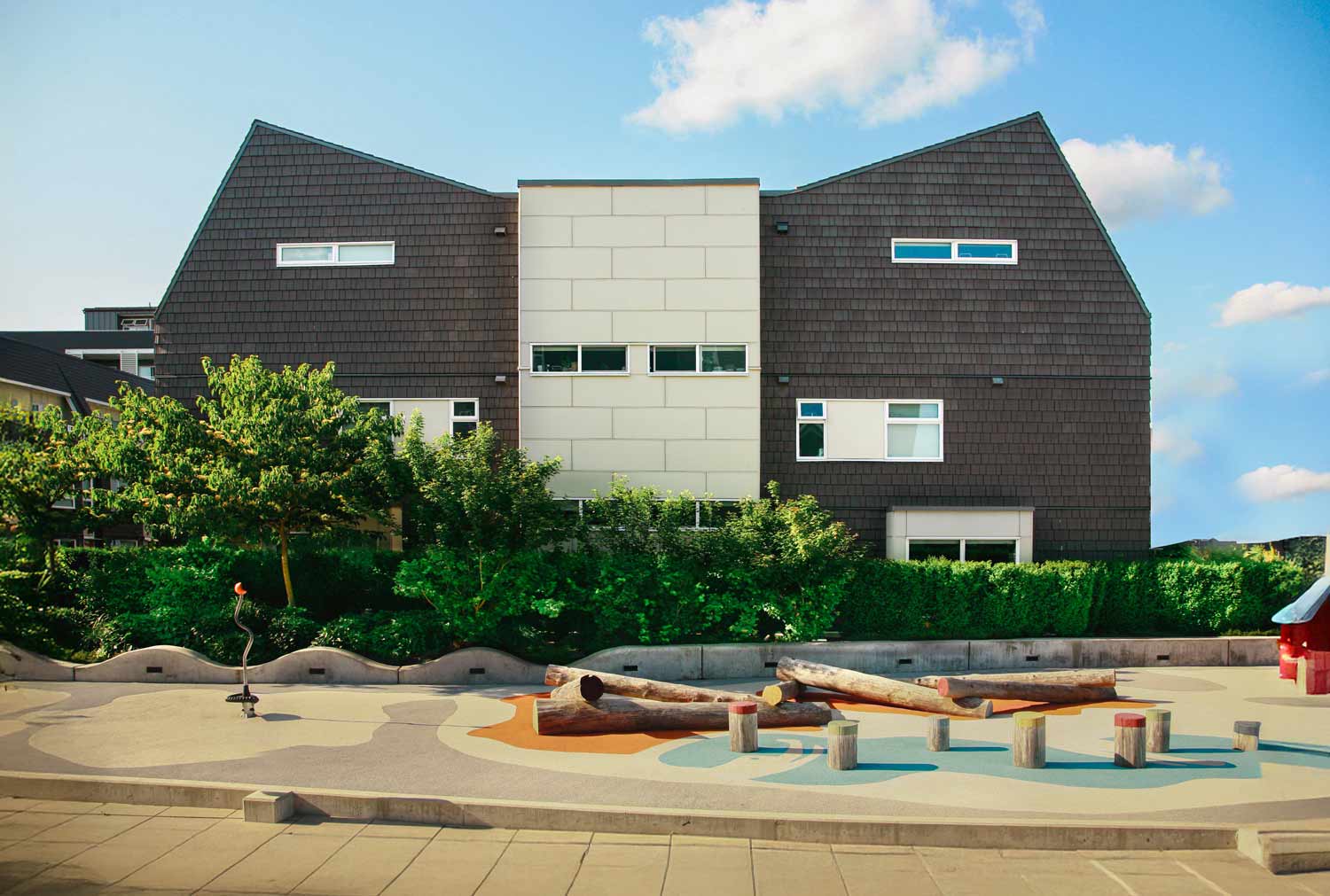 Modern multi-family residential development in Maple Ridge featuring barn-inspired architecture and communal outdoor spaces. Architecture: Iredale Architect