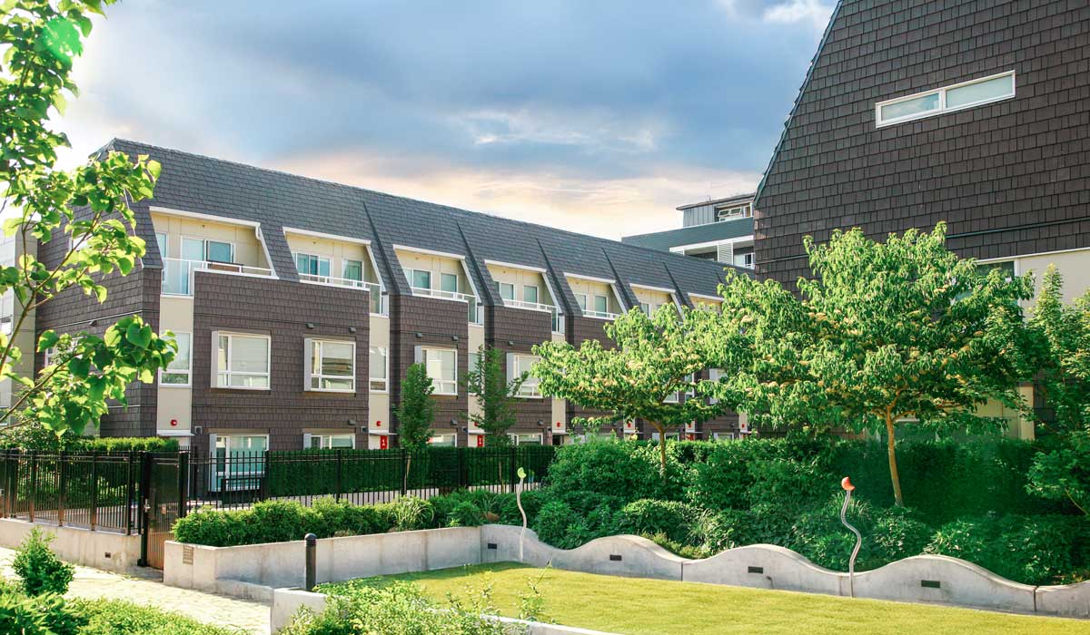 Modern multi-family residential development in Maple Ridge featuring barn-inspired architecture and communal outdoor spaces. Architecture: Iredale Architect